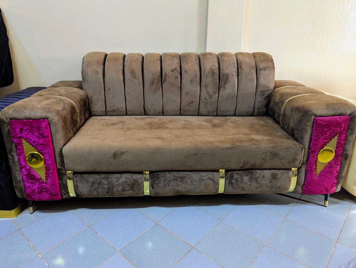 upholstered in a brown velvet sofa